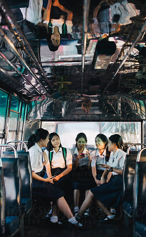 High school students in uniform on the bus in Bangkok
