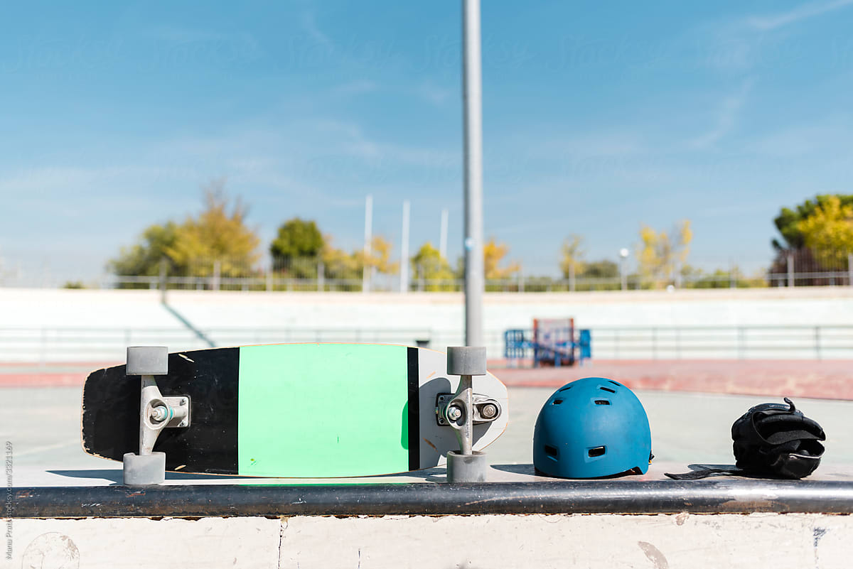 Equipment of a skateboarder on a bench at skate park