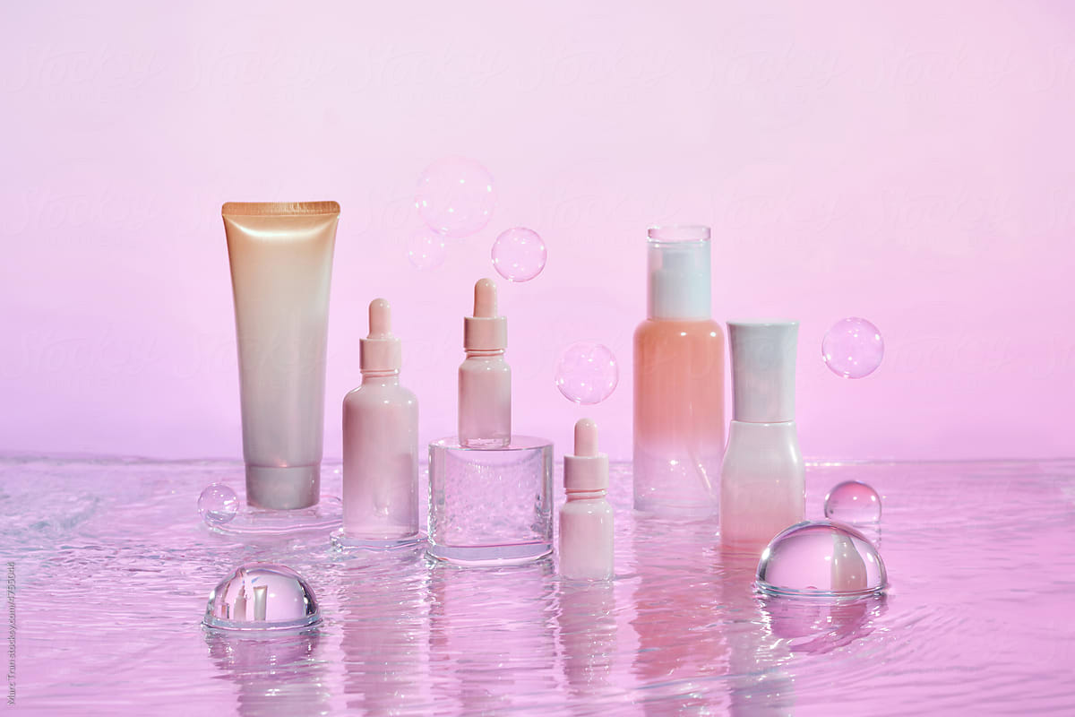 Set of cosmetic products standing in water with ripples against water