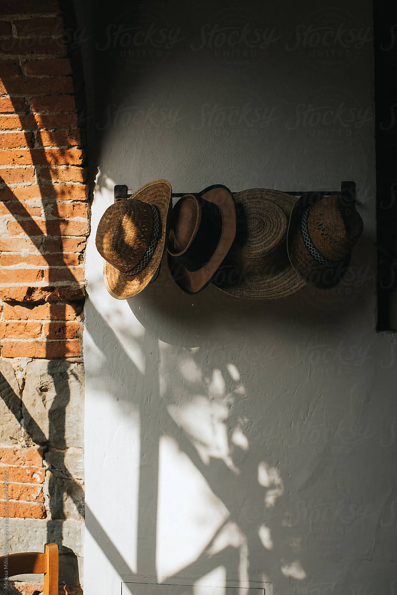Straw hats hanging on a rack