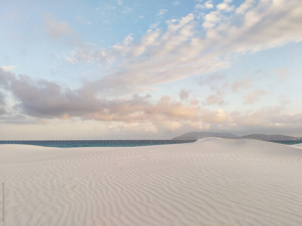White sand beach under soft sunset sky