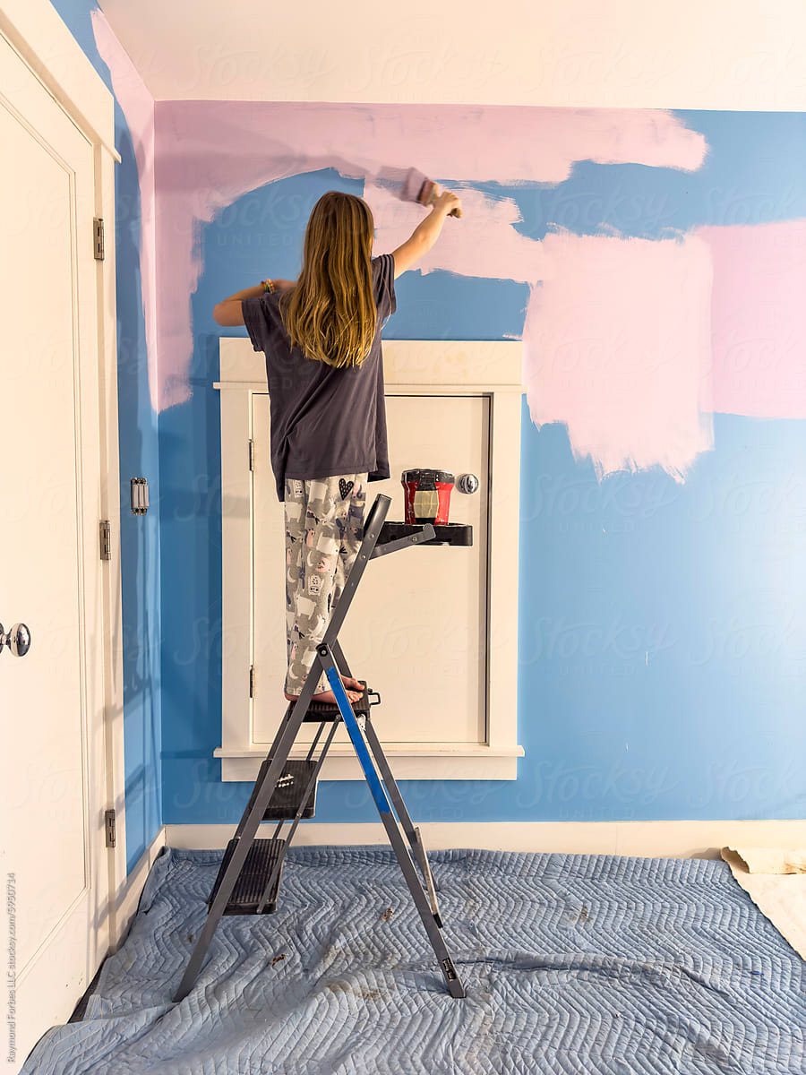 Young girl Painting her colorful bedroom  renovation of room in house