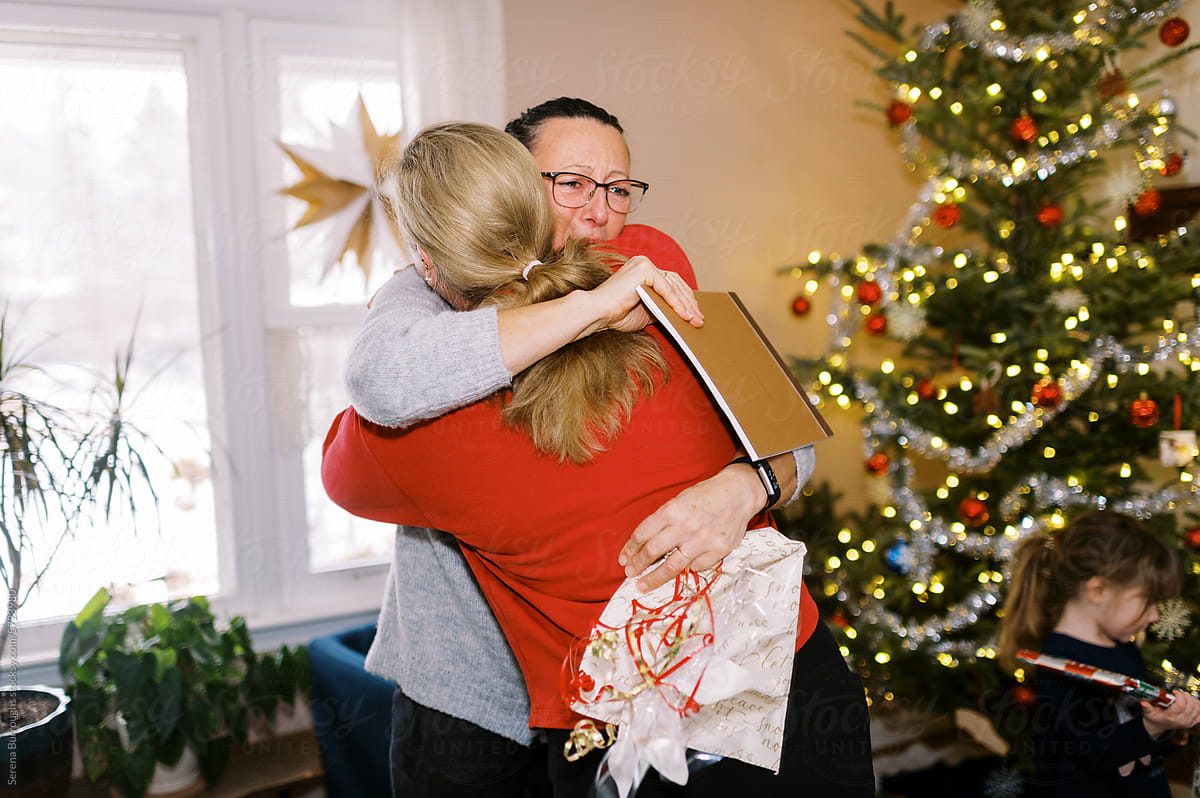 mother and daughter hugging and happy crying  at christmas gifts