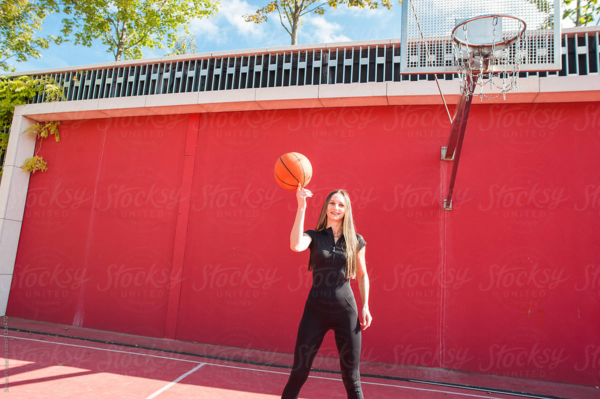 The young woman on a basketball court