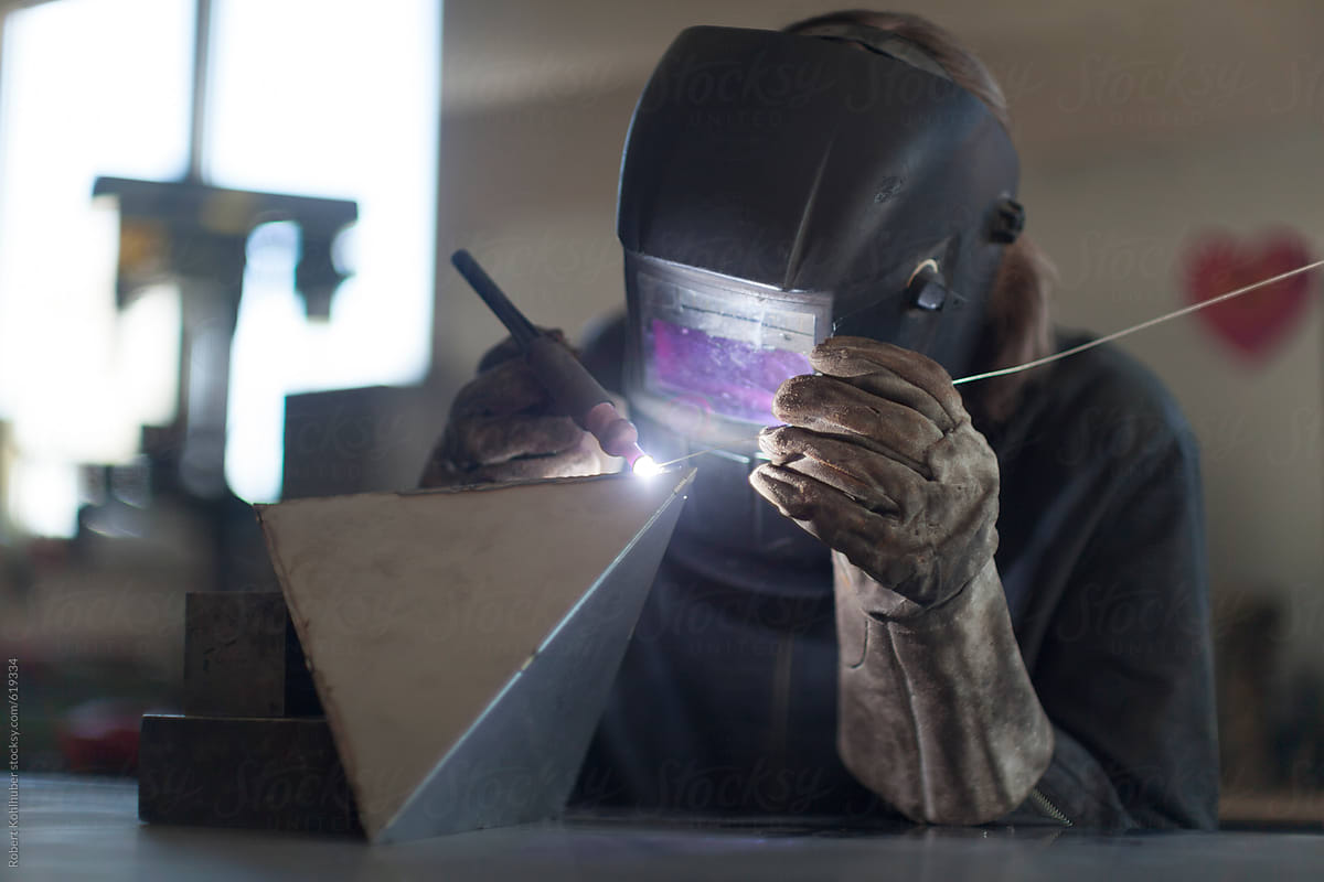 Blacksmith welding in workshop