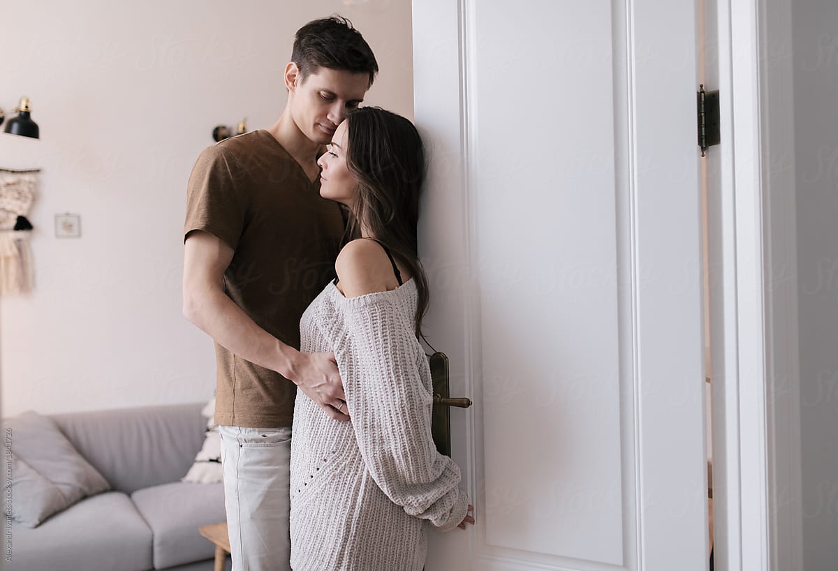 Couple standing at door together