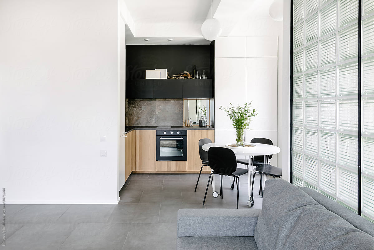 Open kitchen with minimal interior transparent tiles black countertop