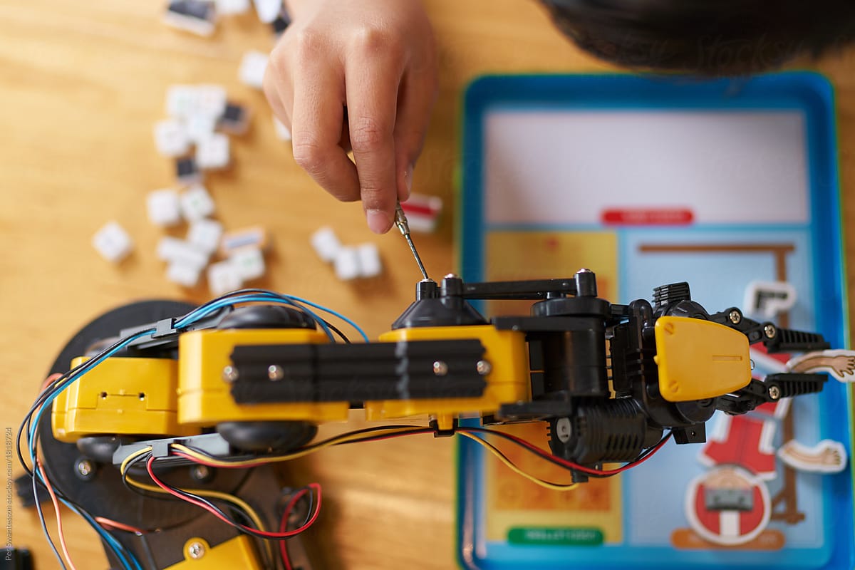 Boy is assembling a robot kit