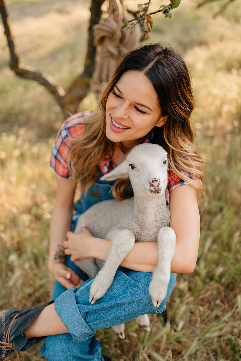 Farm girl with lamb