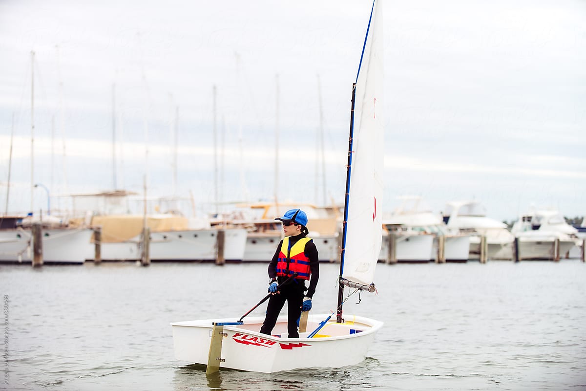 Boy heads out from the yacht club in his dinghy