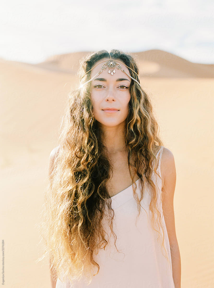 A Portrait Of A Dark Haired Woman In A Desert By Stocksy Contributor
