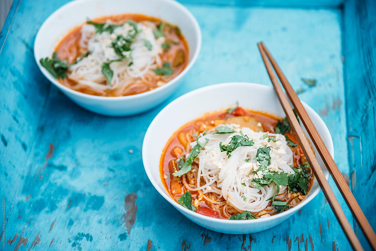 Food: Spicy thai soup with red curry, coconut milk, vegetables a