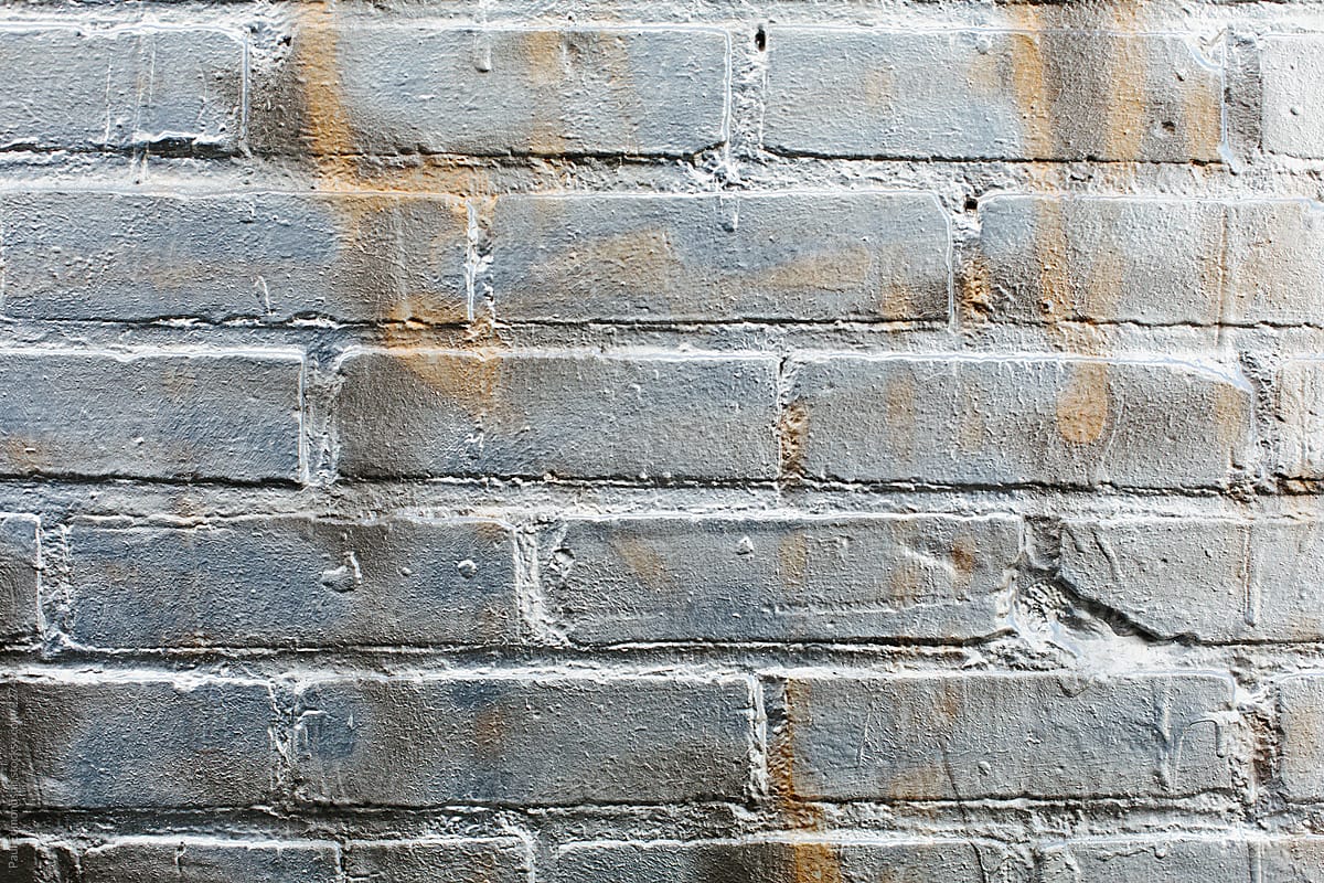 Silver graffiti paint on brick wall, close up