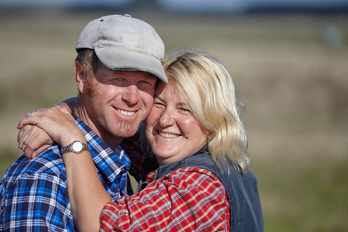 A happy farming couple embrace