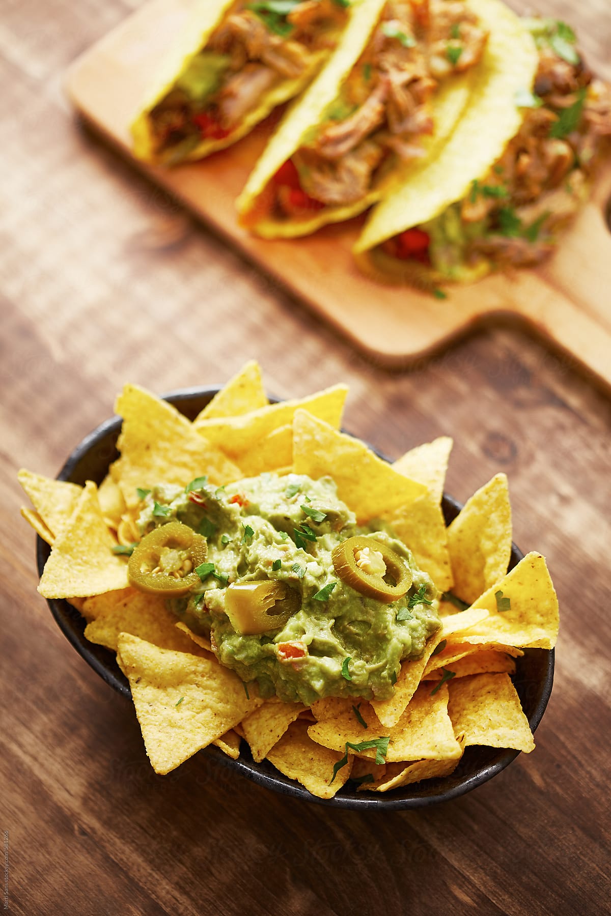 Tortilla chips with guacamole sauce, tacos