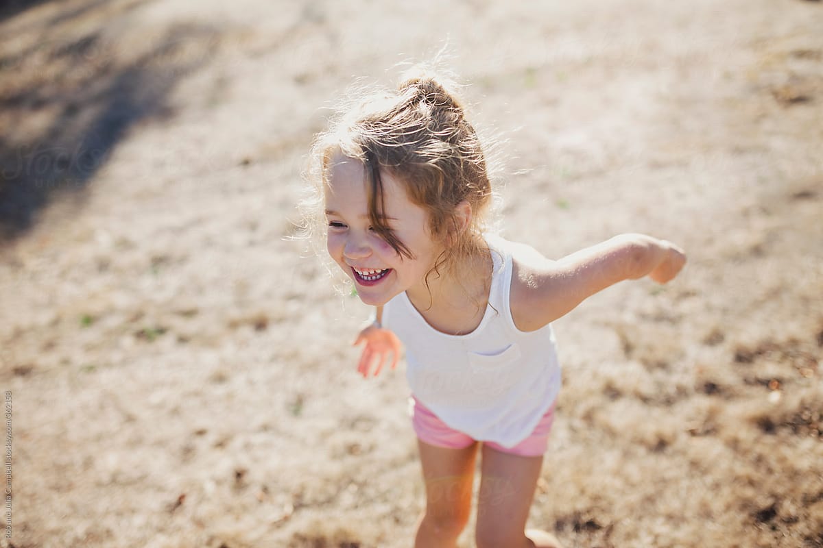 Cute Young Girl Smiling In Long Grass In Summer By Stocksy cute-young-girl-smiling-in-long-grass-in-summer-by-stocksy