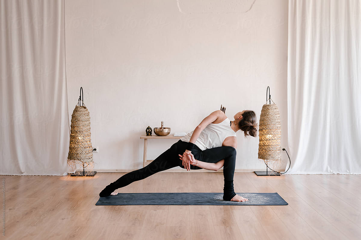 Unrecognizable female doing yoga on mat