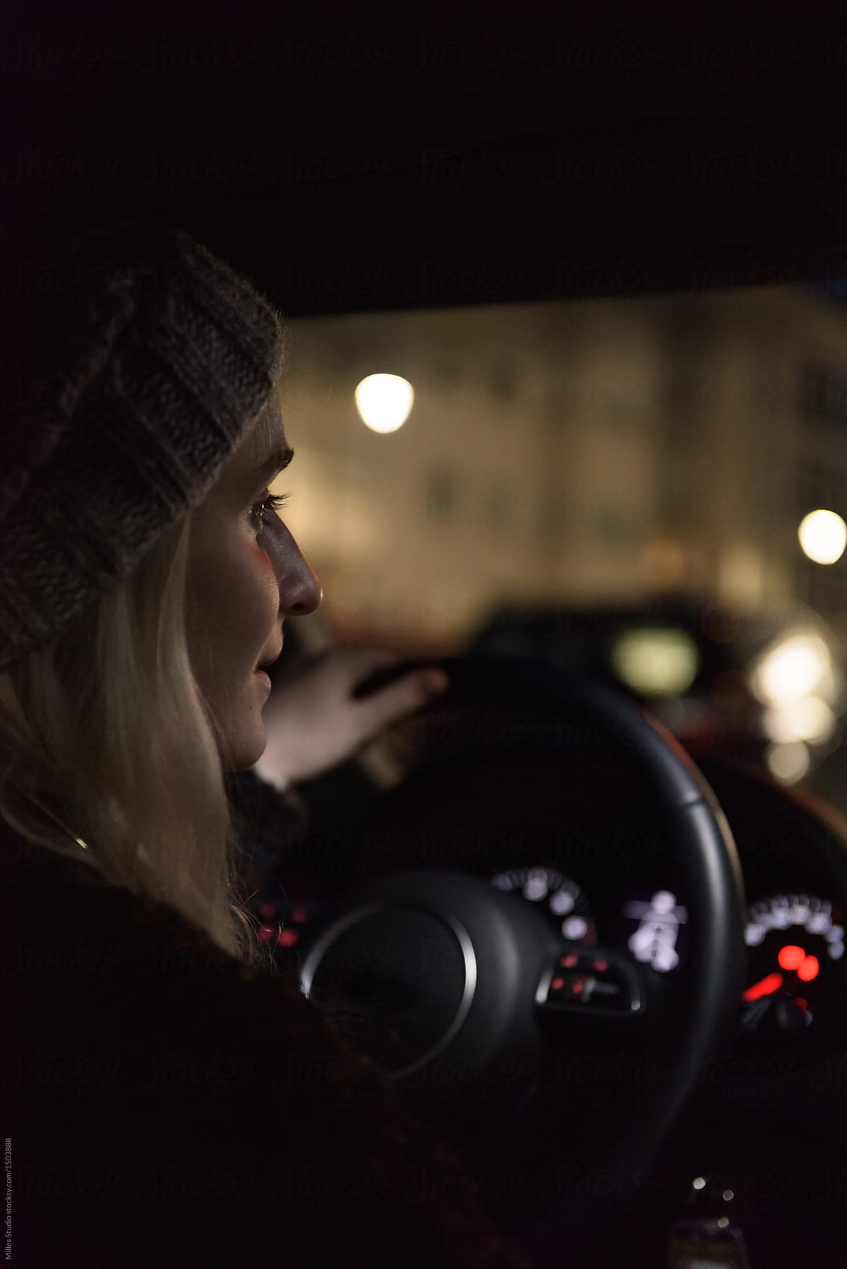 Woman riding car at night
