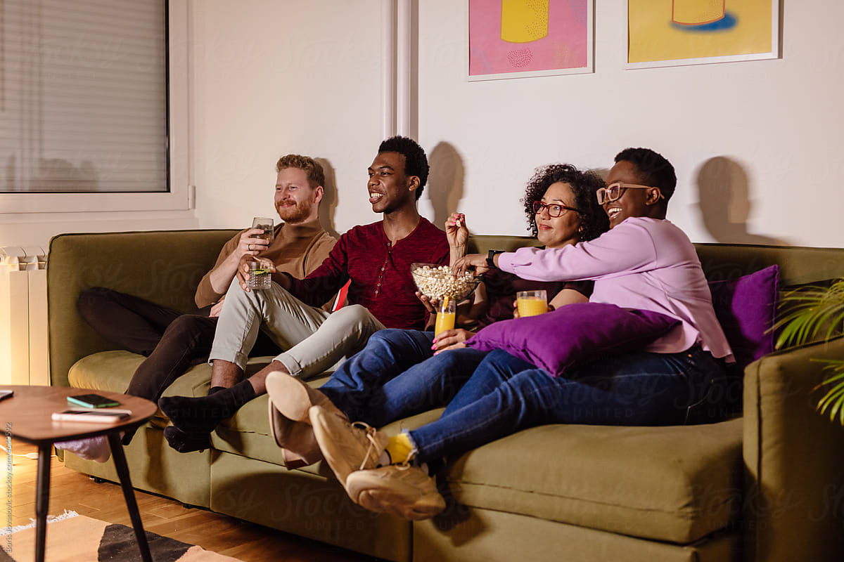 Happy Cheerful Friends Watching Tv By Stocksy Contributor Boris