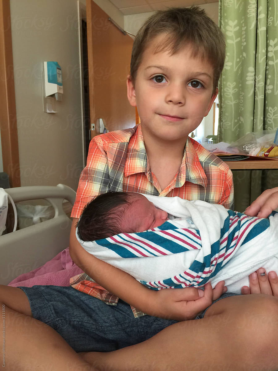 Big Brother Holding His Baby Brother For The First Time by Cameron Whitman