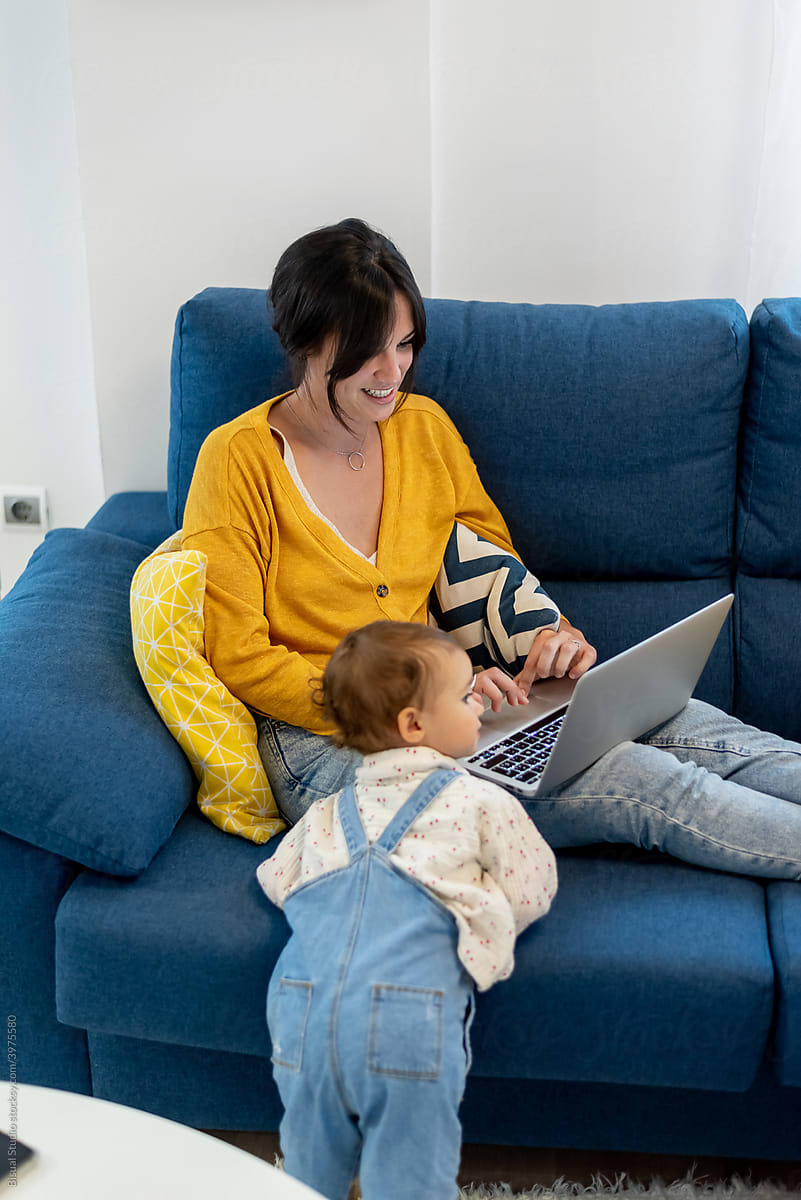Mother and child watching carton together on laptop