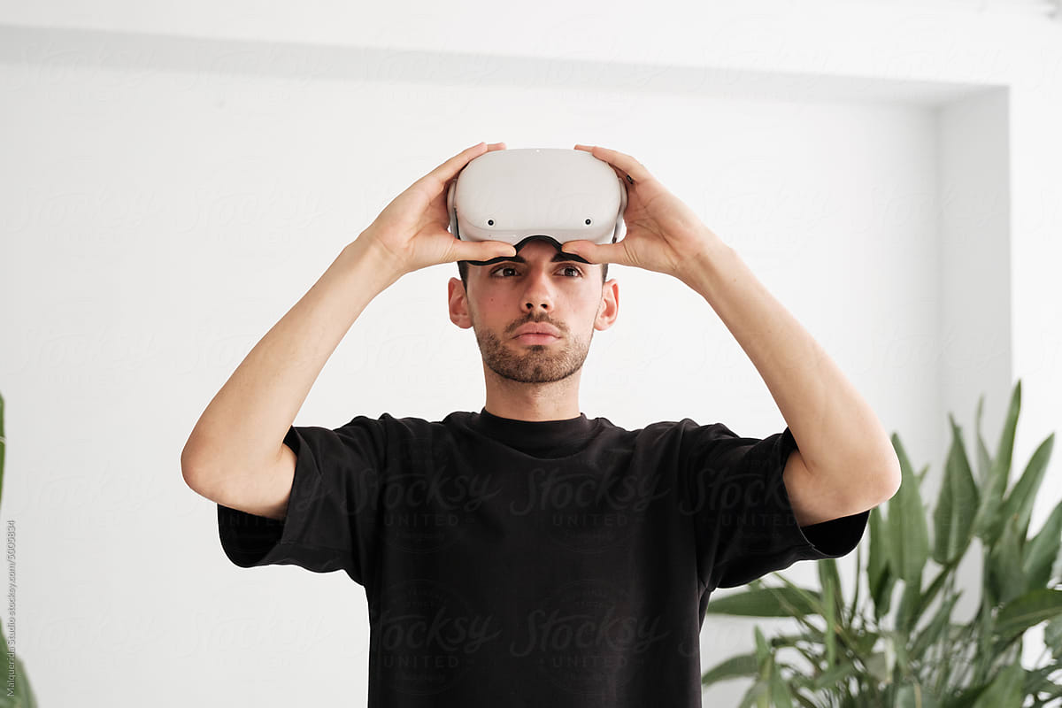 Man Taking Off VR glasses