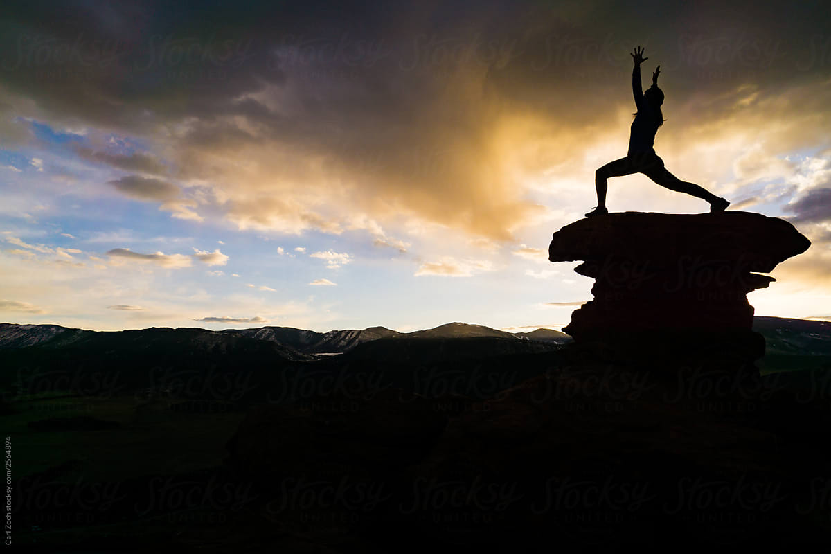 Practicing Yoga at sunrise in the mountains.