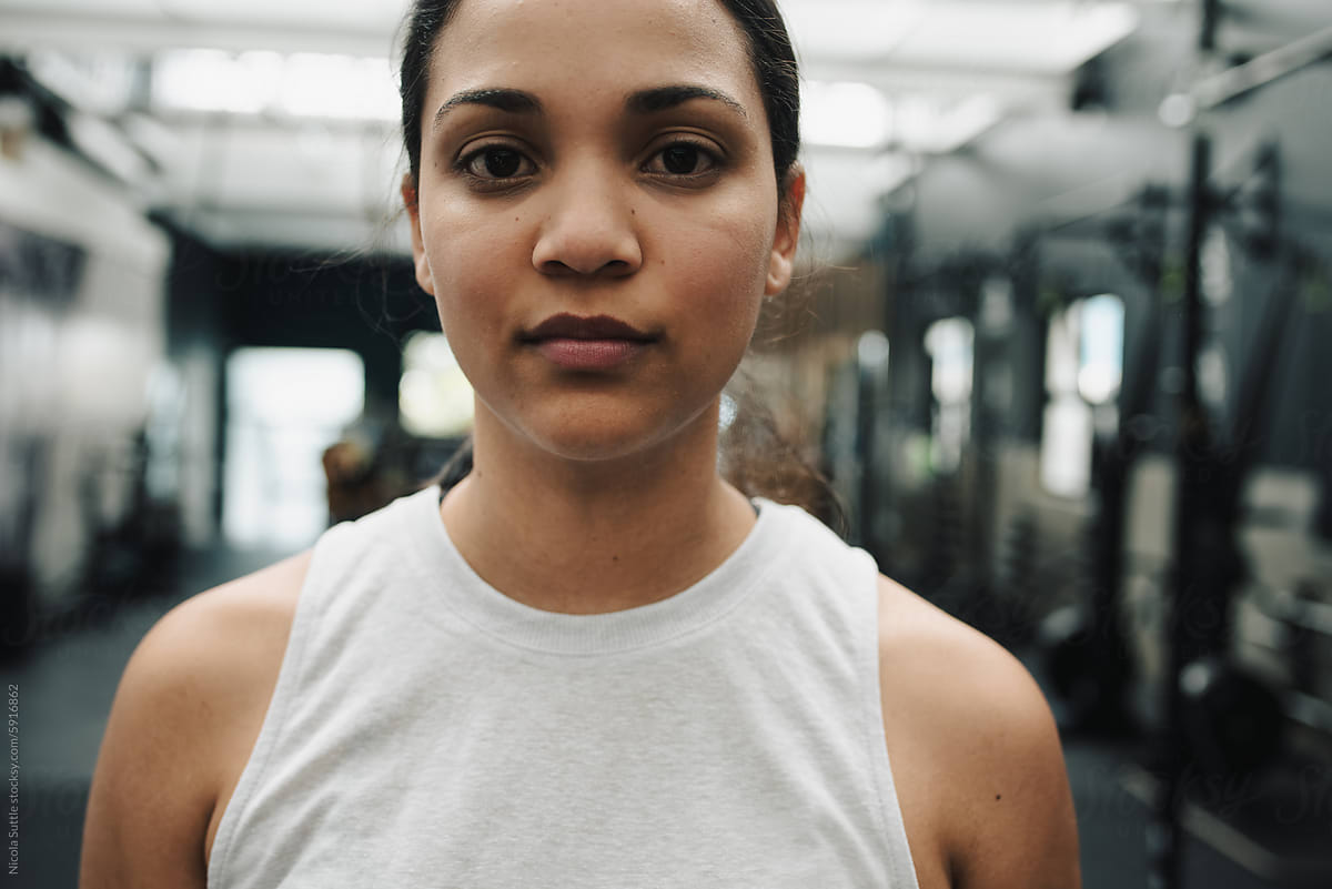 Serious woman in modern fitness center looking at camera