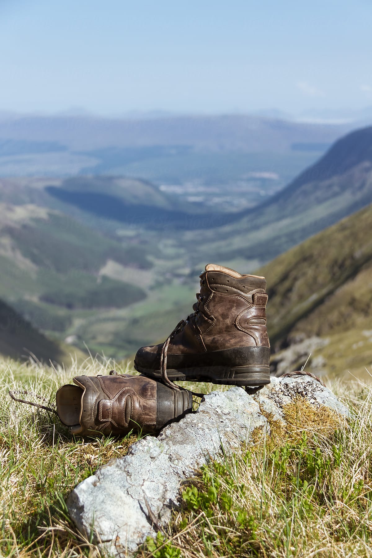 mountaineering boot with scottish highlands in the back