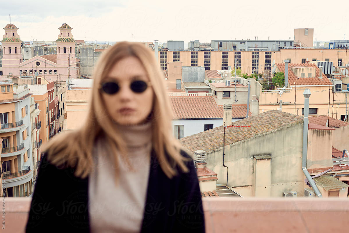 Unfocused Woman In Sunglasses Against The City Del Colaborador De Stocksy Guille Faingold 