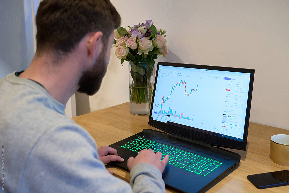 A man checking his cryptocurrency trade at home