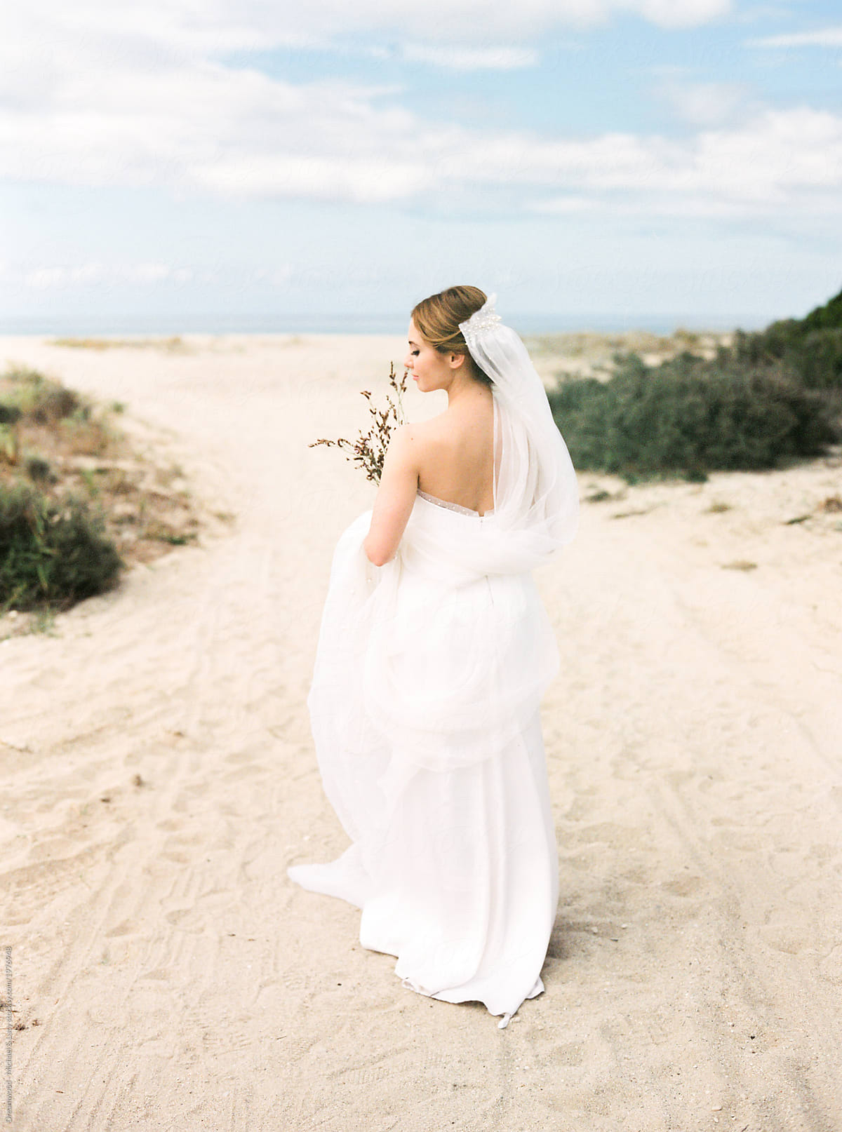 Romantic girl in bridal dress on beach