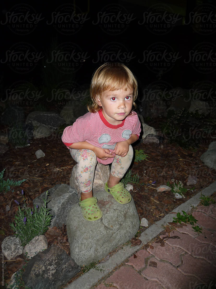 baby poop: concentrated girl sitting on the big stones