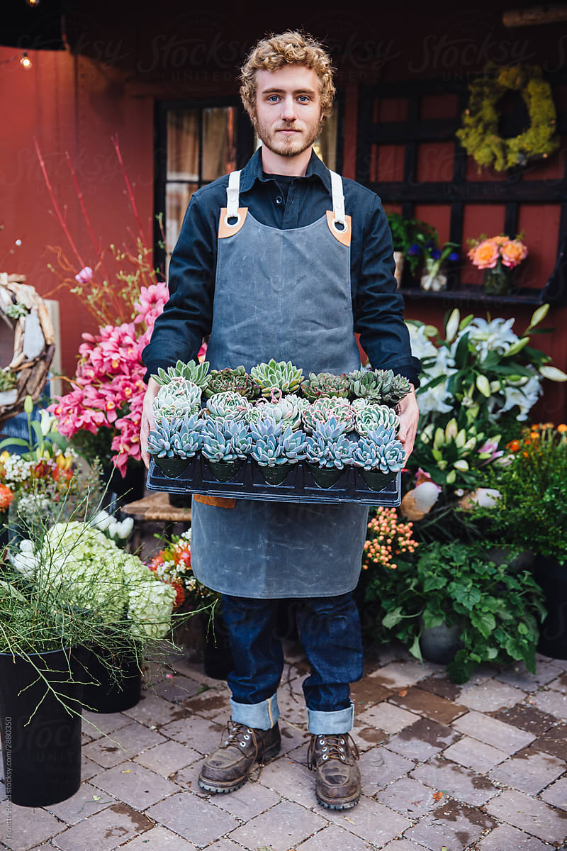 Flower shop owner holding succulents