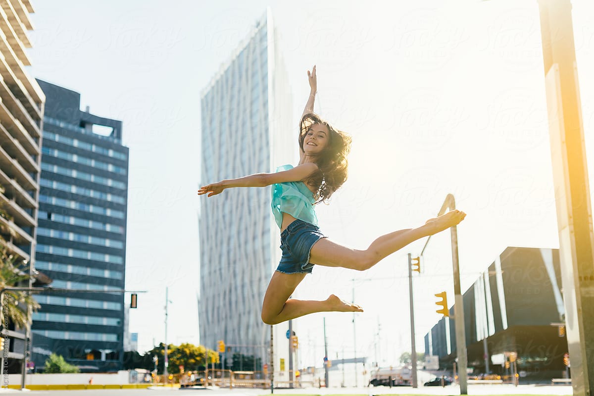 Young dancer jumping on urban background