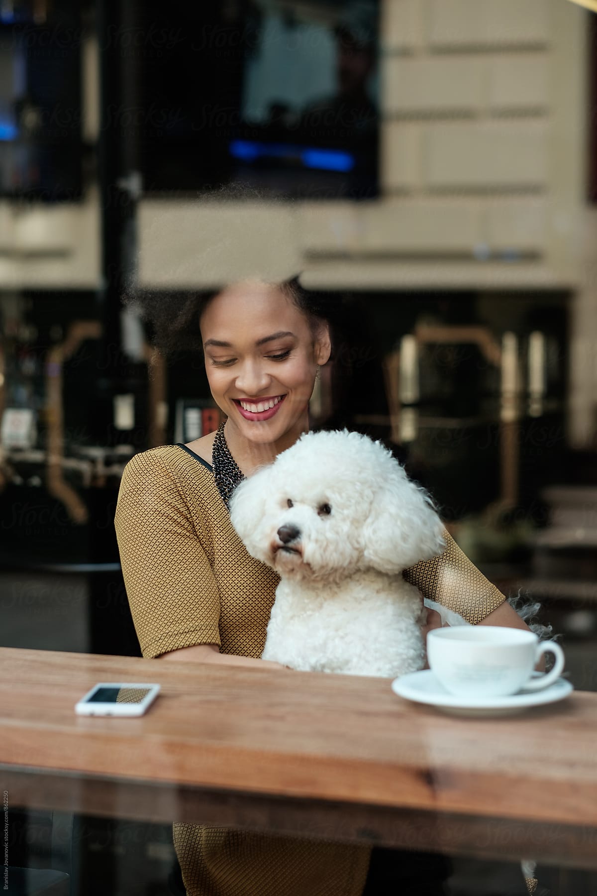Beautiful Young Woman Sitting At The Cafe With Her Dog