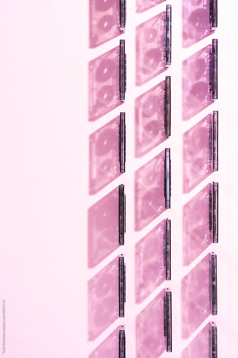 Cassette tapes aligned on pink background