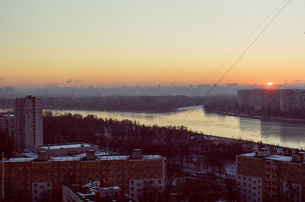 Golden hour at the Moskva River: cityscape with buildings and nature