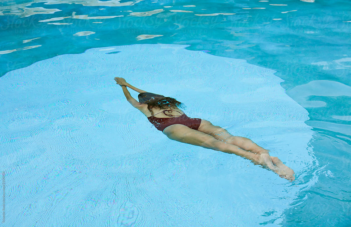 Woman Swimming Underwater In Pool By Stocksy Contributor Trinette