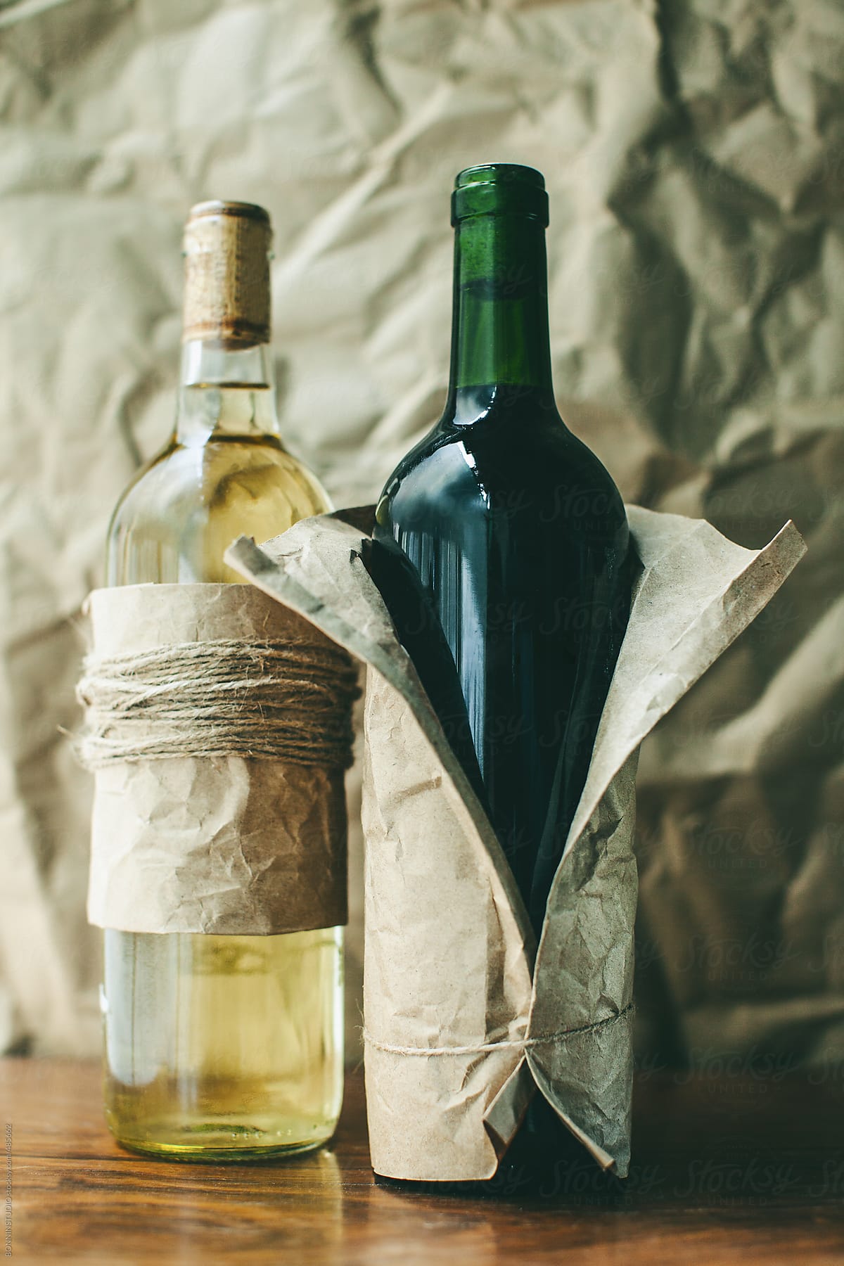 Two wrapped red and white wine bottles.
