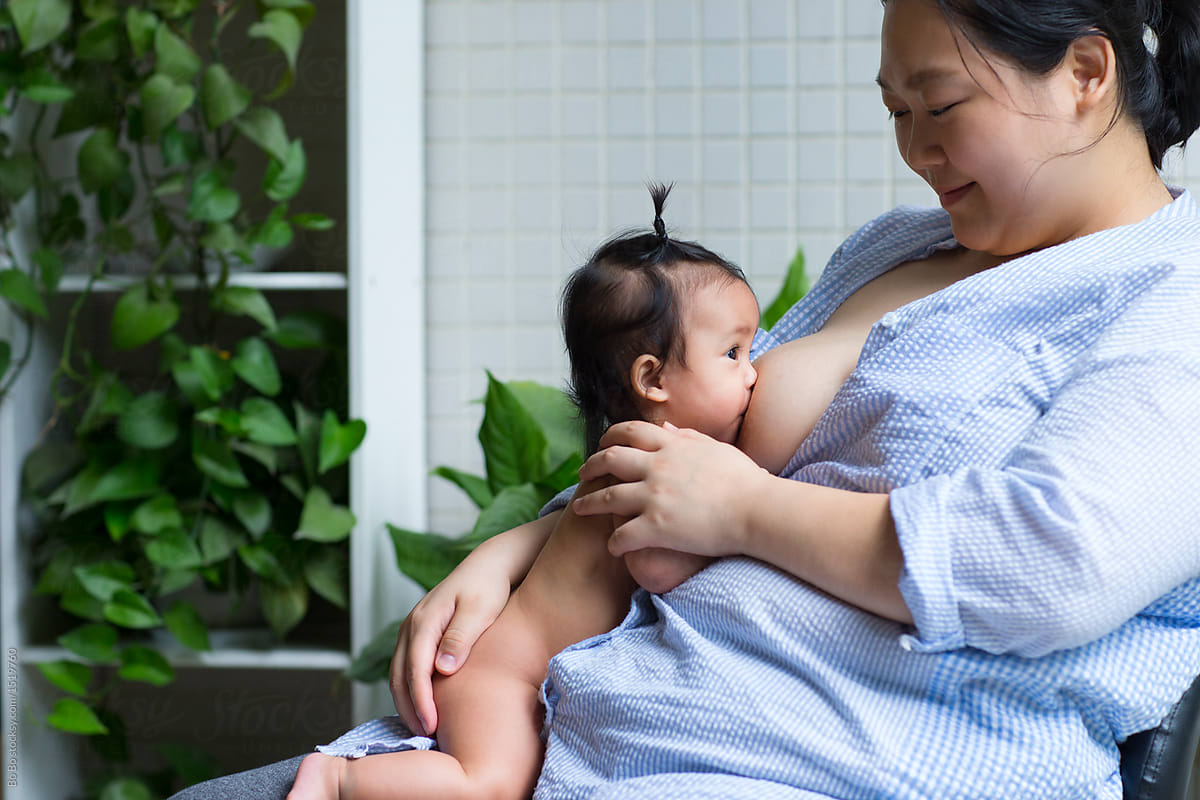 Asian Mother With Her Baby Girl In Home By Stocksy Contributor Bo Bo Stocksy