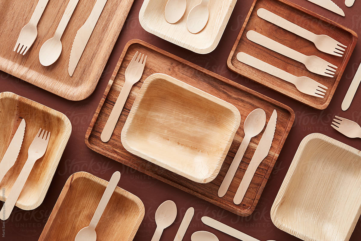 Wooden dishes and cutlery in composition