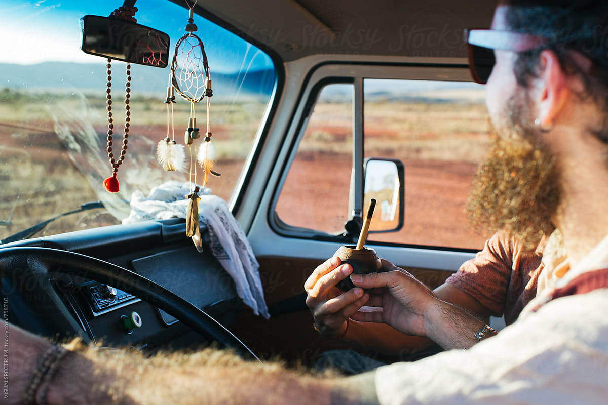 On The Road - Two Men Sharing Mate While Driving Camper Van Through South America
