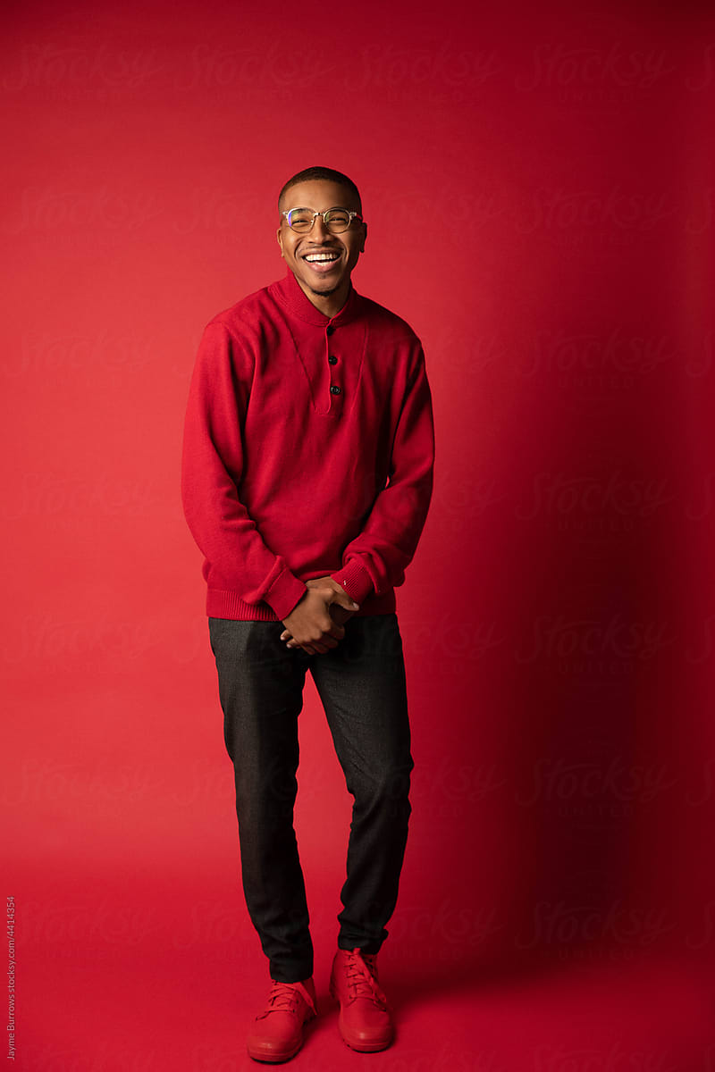 Young Man Laughs in Red Sweater