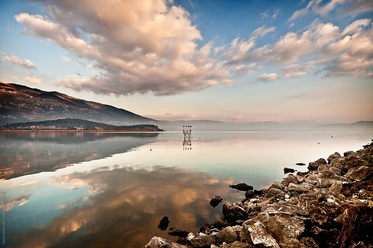 clouds reflected in a lake in greece