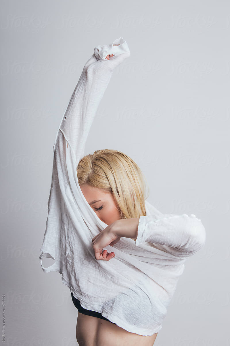 Woman Taking Shirt Off. by Studio Firma.