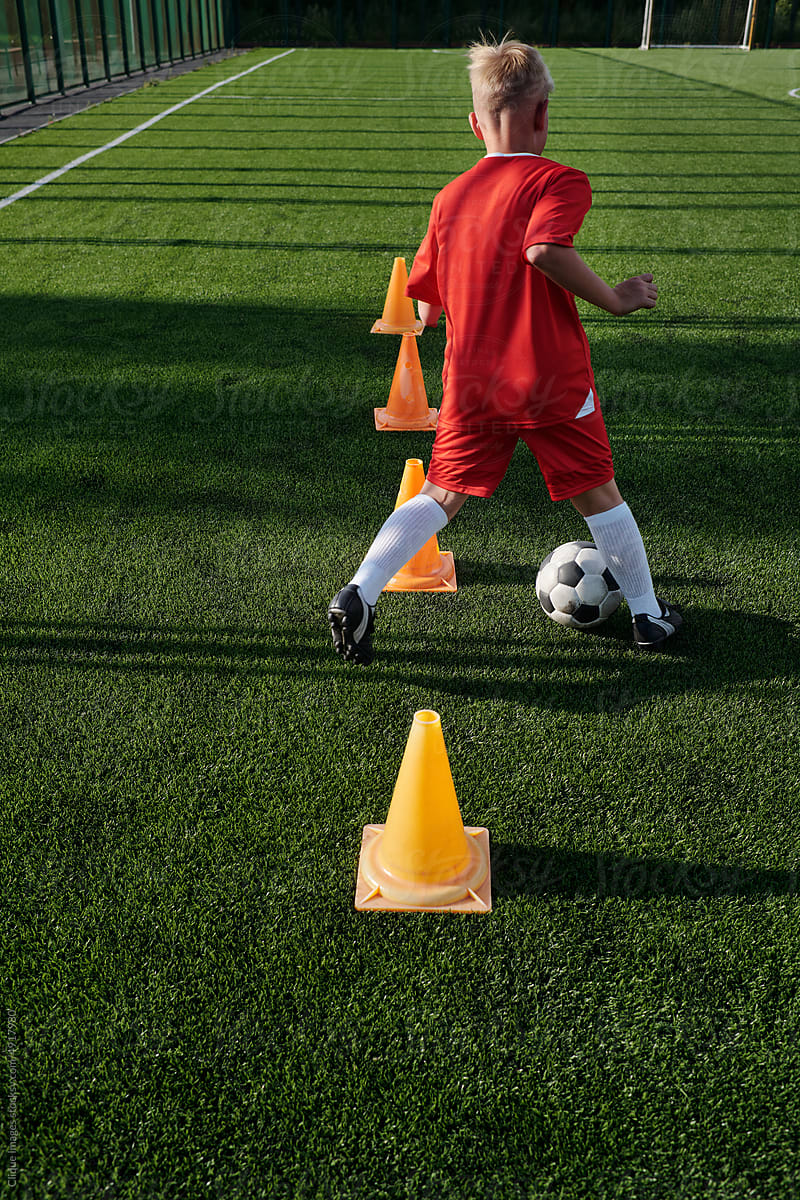 Boy Exercising On Soccer Field