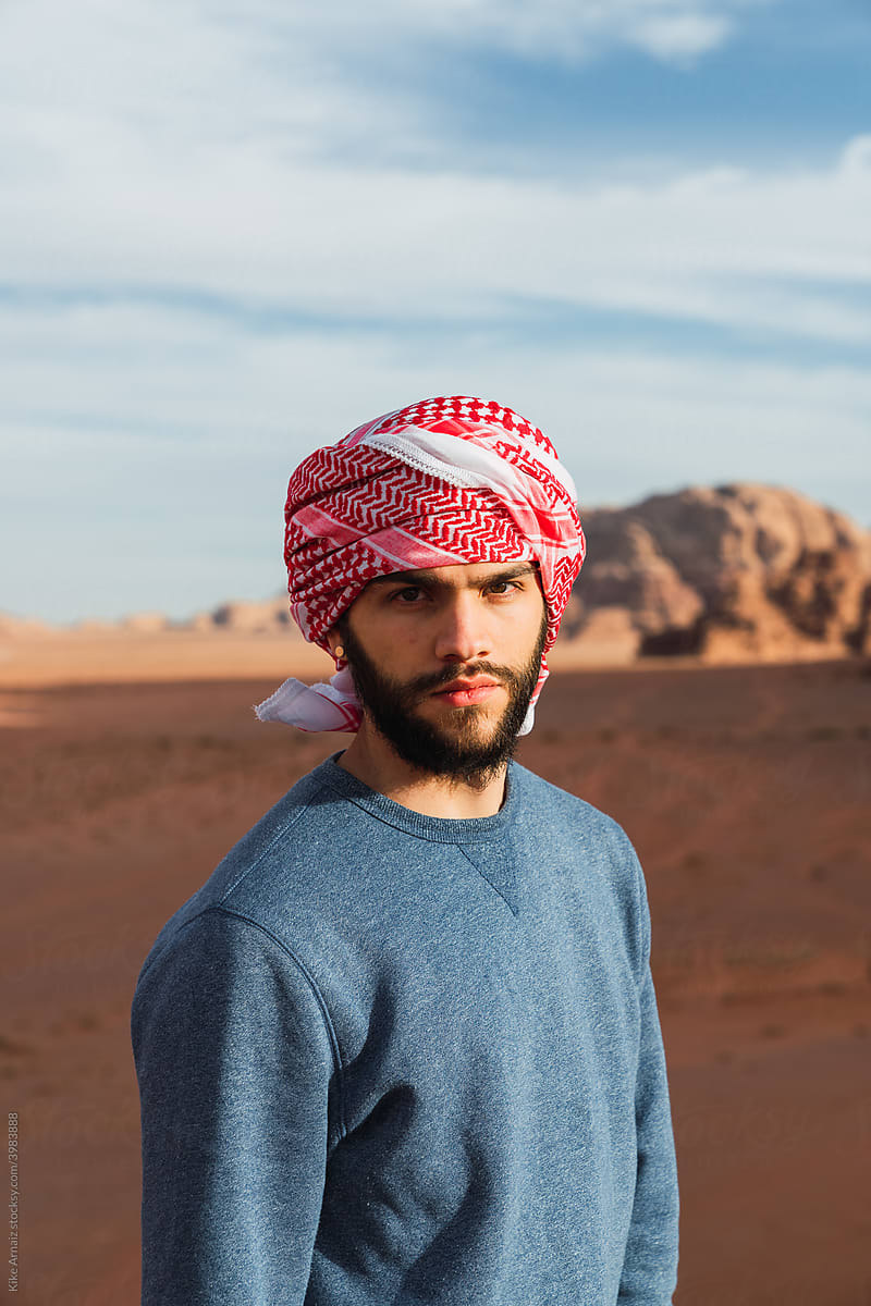 Arabic man between sand lands in desert