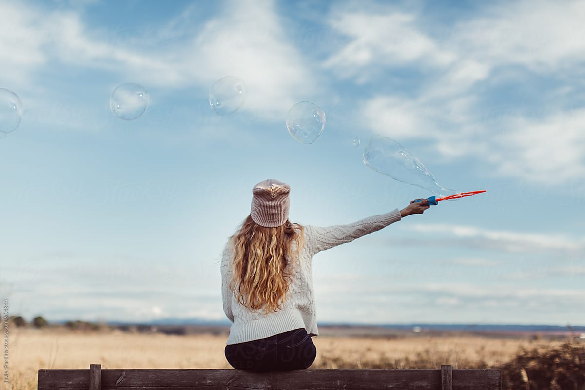 Woman Playing With Bubble By Stocksy Contributor Javier Pardina Stocksy