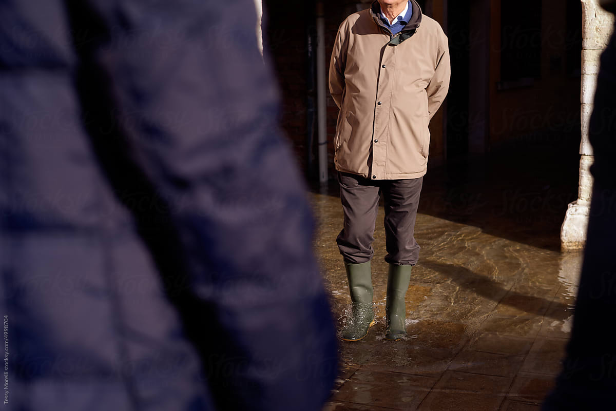 Senior man walking in the flooded streets of Venice